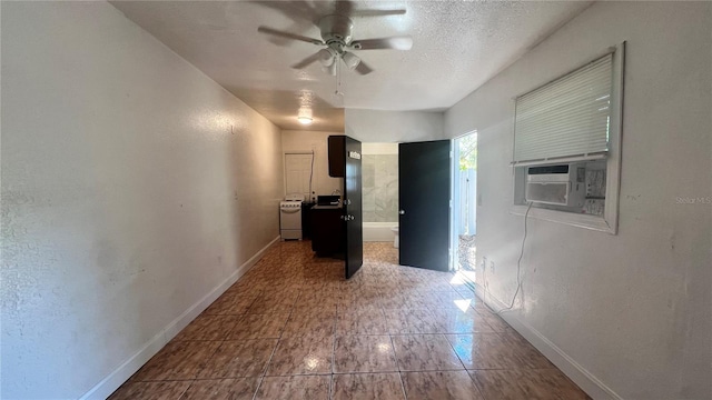 interior space with cooling unit, a textured ceiling, and baseboards