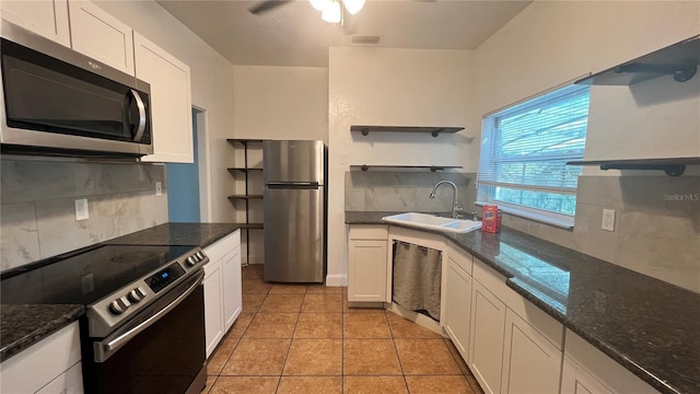 kitchen with open shelves, appliances with stainless steel finishes, a sink, and decorative backsplash