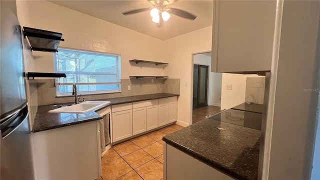 kitchen featuring light tile patterned floors, white cabinets, black electric cooktop, open shelves, and a sink