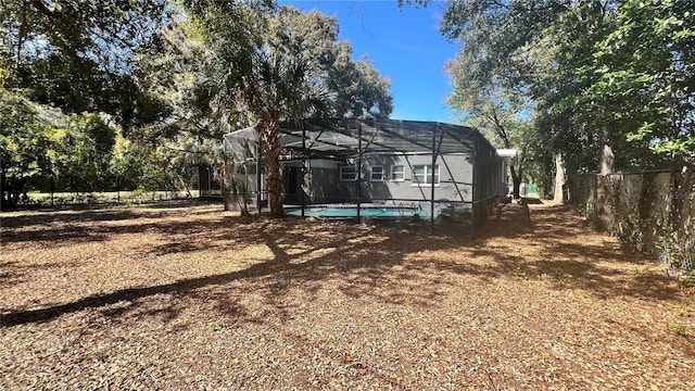 view of yard featuring a fenced in pool, a lanai, and a fenced backyard