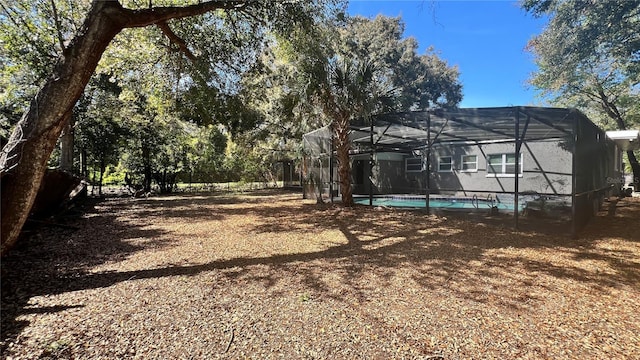 view of yard featuring a lanai and an outdoor pool