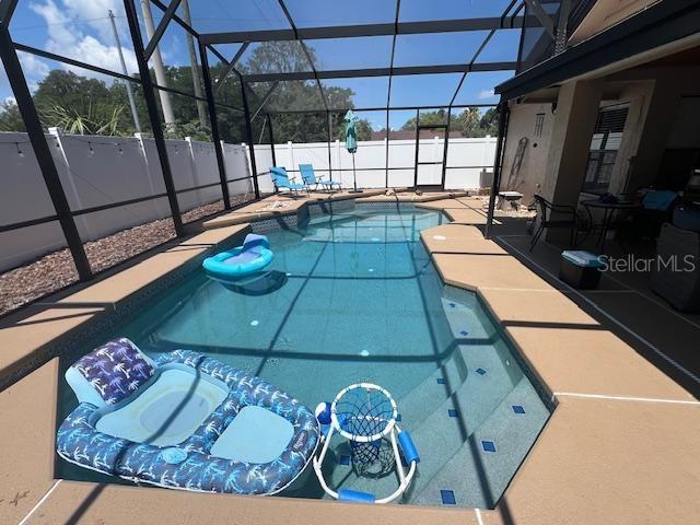 3509 S Saint Lucie Dr, Casselberry, FL 32707 - view of swimming pool with a fenced backyard, a patio, and glass enclosure