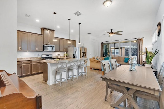 2312 Datura Loop, Saint Cloud, FL 34772 - kitchen featuring stainless steel appliances, light wood-type flooring, and visible vents