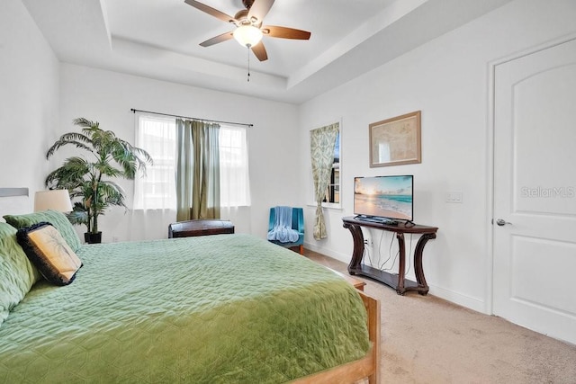 2312 Datura Loop, Saint Cloud, FL 34772 - bedroom featuring light carpet, ceiling fan, baseboards, and a raised ceiling