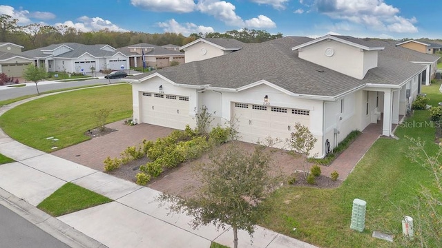 2312 Datura Loop, Saint Cloud, FL 34772 - view of front of house featuring decorative driveway, roof with shingles, a front yard, a garage, and a residential view