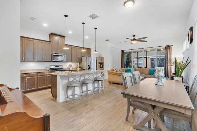 kitchen with appliances with stainless steel finishes, visible vents, and light wood-style floors