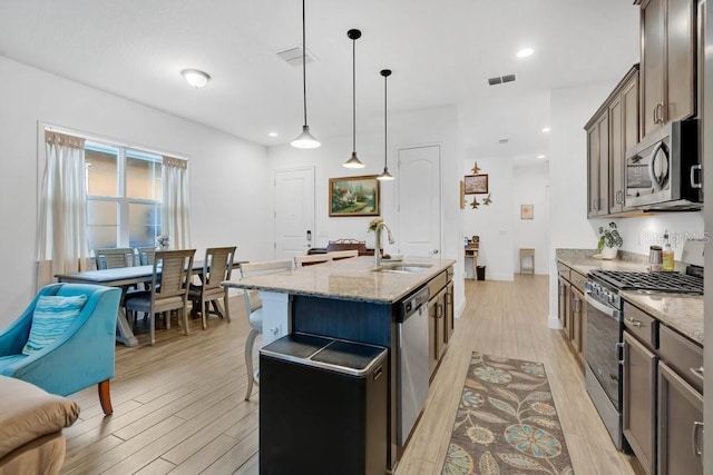 2312 Datura Loop, Saint Cloud, FL 34772 - kitchen with stainless steel appliances, light wood-type flooring, visible vents, and a sink