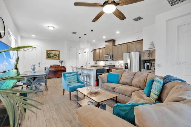 2312 Datura Loop, Saint Cloud, FL 34772 - living area with ceiling fan, visible vents, and light wood-style floors