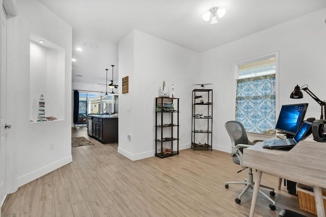 2312 Datura Loop, Saint Cloud, FL 34772 - office area featuring baseboards, a sink, and light wood finished floors