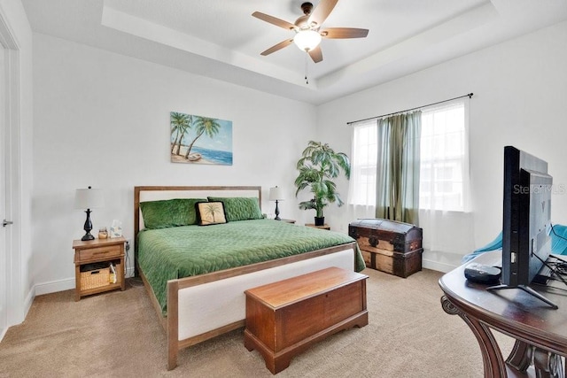 2312 Datura Loop, Saint Cloud, FL 34772 - bedroom with light carpet, ceiling fan, a raised ceiling, and baseboards