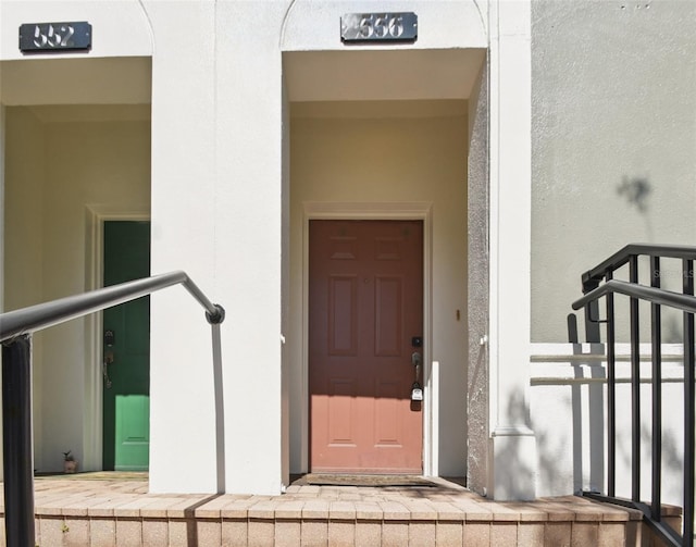 view of exterior entry with stucco siding