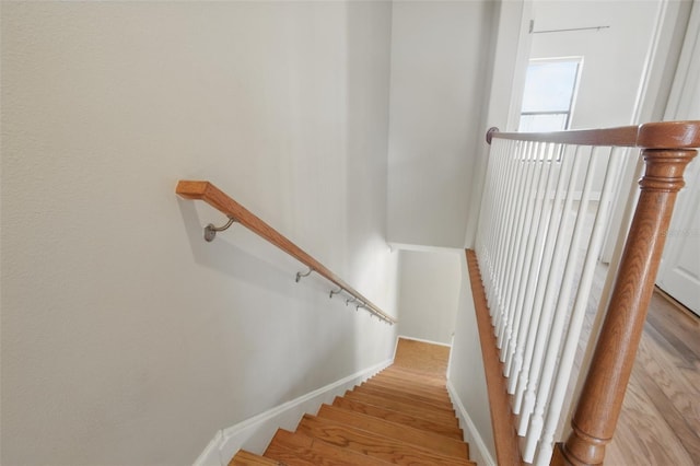 stairs featuring baseboards and wood finished floors