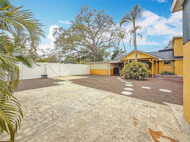 view of yard with a gate, a patio area, and fence