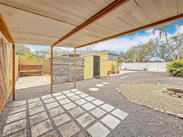 view of patio / terrace featuring an outdoor fire pit, a gate, and a fenced backyard