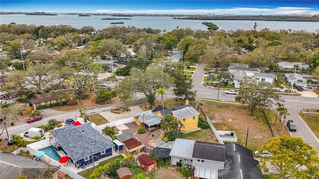 drone / aerial view with a water view and a residential view