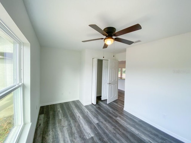 spare room with dark wood finished floors and baseboards