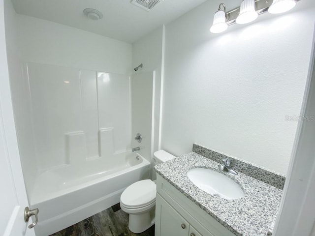 full bath featuring toilet, wood finished floors, vanity, visible vents, and tub / shower combination