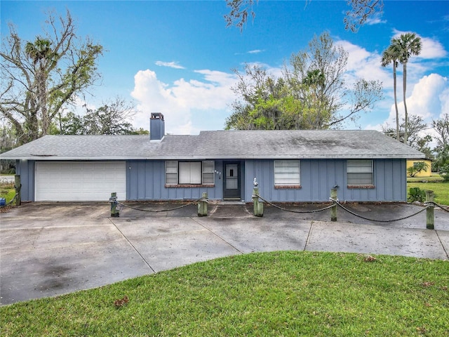 ranch-style home featuring board and batten siding, concrete driveway, a chimney, and a garage