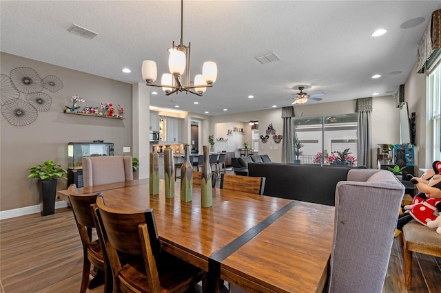 dining room featuring baseboards, visible vents, a textured ceiling, and recessed lighting