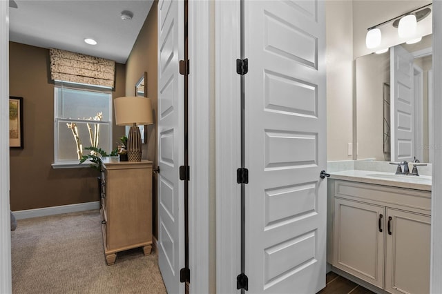 bathroom with vanity and baseboards