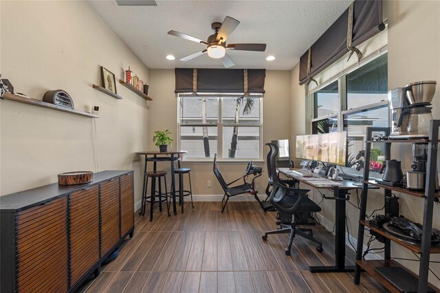 office featuring ceiling fan, baseboards, a textured ceiling, and recessed lighting