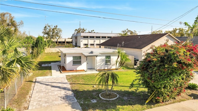 view of front of home with stucco siding and a front yard