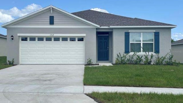 ranch-style home with roof with shingles, stucco siding, a garage, driveway, and a front lawn