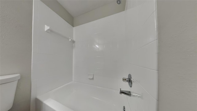 bathroom featuring toilet and shower / bathtub combination