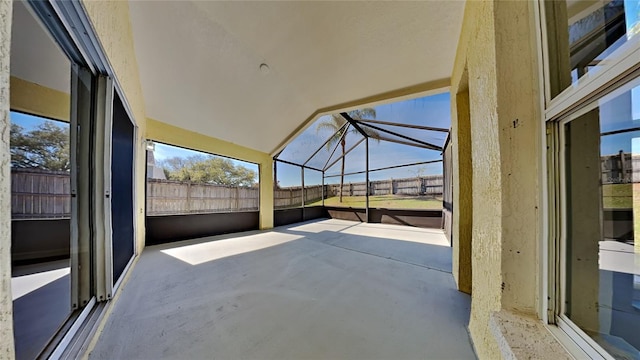 unfurnished sunroom with vaulted ceiling