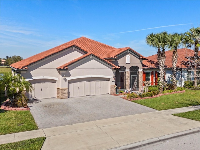 2541 Shoal Bass Way, Kissimmee, FL 34746 - mediterranean / spanish-style home with stone siding, stucco siding, driveway, and a garage