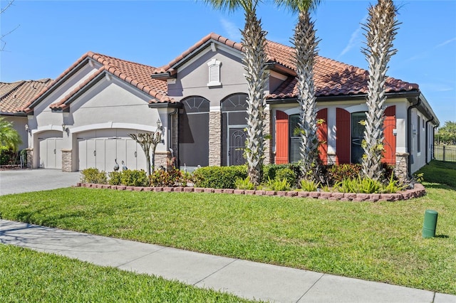2541 Shoal Bass Way, Kissimmee, FL 34746 - mediterranean / spanish-style house with stone siding, a garage, a front lawn, and concrete driveway