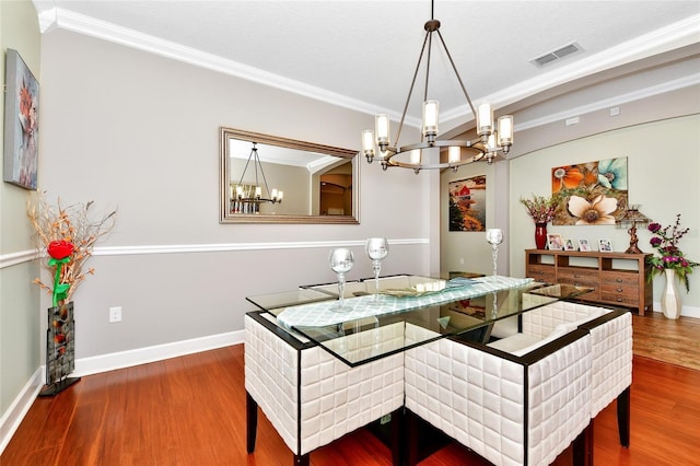 2541 Shoal Bass Way, Kissimmee, FL 34746 - dining space featuring a chandelier, wood finished floors, ornamental molding, and baseboards