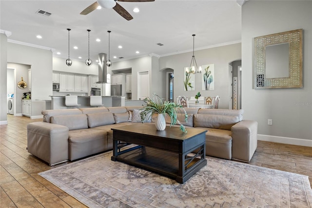 2541 Shoal Bass Way, Kissimmee, FL 34746 - living room featuring a chandelier, light wood-style floors, a ceiling fan, baseboards, and recessed lighting