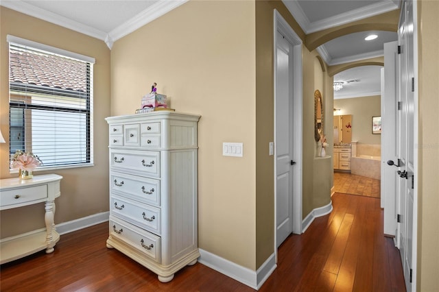 2541 Shoal Bass Way, Kissimmee, FL 34746 - hall with arched walkways, crown molding, dark wood-type flooring, and baseboards