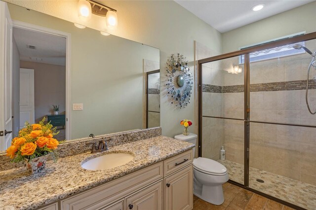 2541 Shoal Bass Way, Kissimmee, FL 34746 - full bathroom featuring vanity, toilet, visible vents, and a tile shower