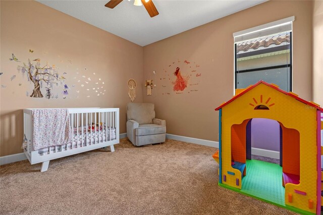 2541 Shoal Bass Way, Kissimmee, FL 34746 - carpeted bedroom featuring baseboards, a ceiling fan, and a crib