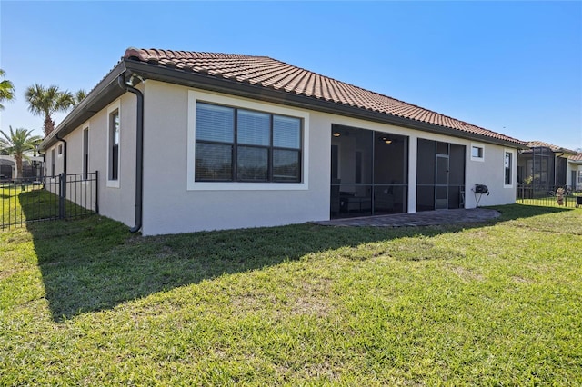 2541 Shoal Bass Way, Kissimmee, FL 34746 - rear view of house featuring stucco siding, a tiled roof, and a sunroom