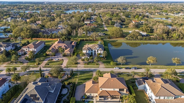 drone / aerial view with a residential view and a water view