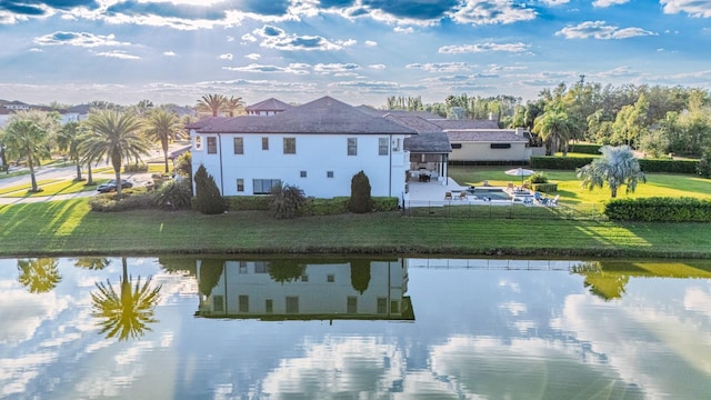 exterior space with a water view and a yard