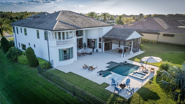 rear view of property with an outdoor living space with a fire pit, a patio area, a yard, and a fenced backyard