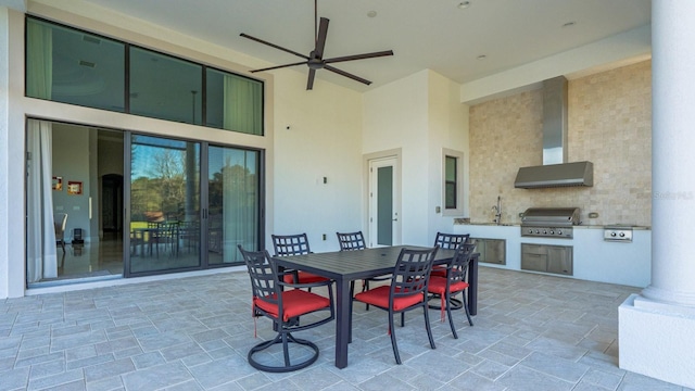 view of patio featuring a ceiling fan, area for grilling, outdoor dining area, exterior kitchen, and a sink