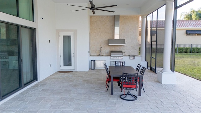 view of patio / terrace featuring outdoor dining area, an outdoor kitchen, a grill, fence, and ceiling fan