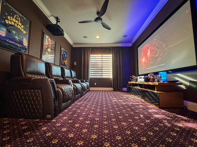 home theater room with ornamental molding, carpet flooring, ceiling fan, a textured ceiling, and baseboards