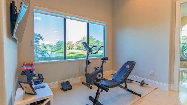 workout room with tile patterned floors and baseboards