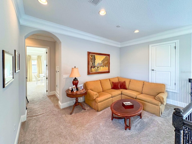 living room featuring baseboards, arched walkways, light colored carpet, a textured ceiling, and crown molding