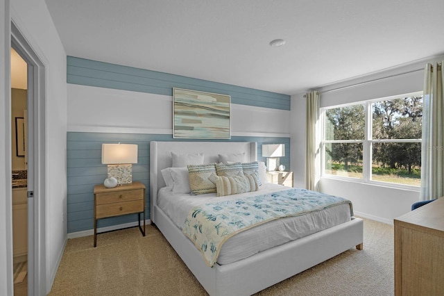 bedroom featuring carpet flooring and wooden walls