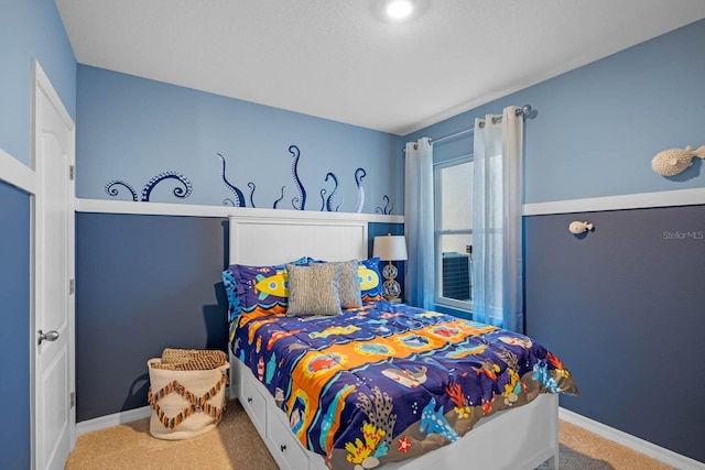 bedroom featuring baseboards and carpet flooring