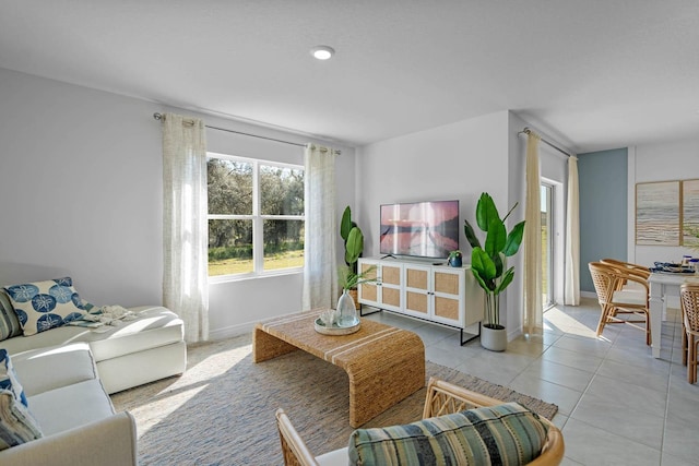 living area featuring baseboards and light tile patterned floors