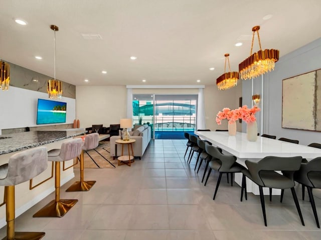 dining space featuring light tile patterned floors and recessed lighting