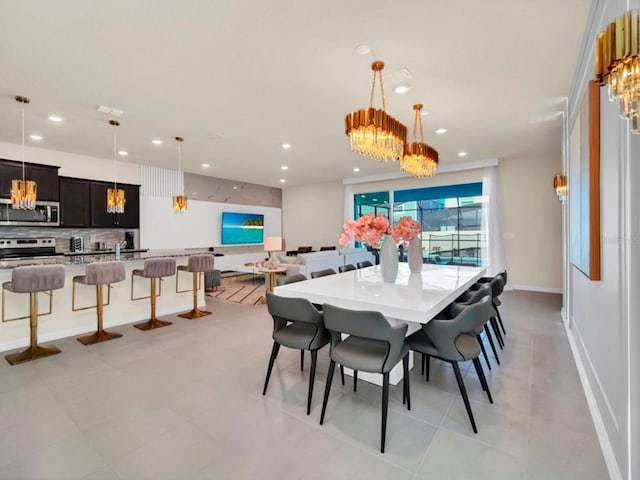 dining area with recessed lighting, baseboards, and a notable chandelier